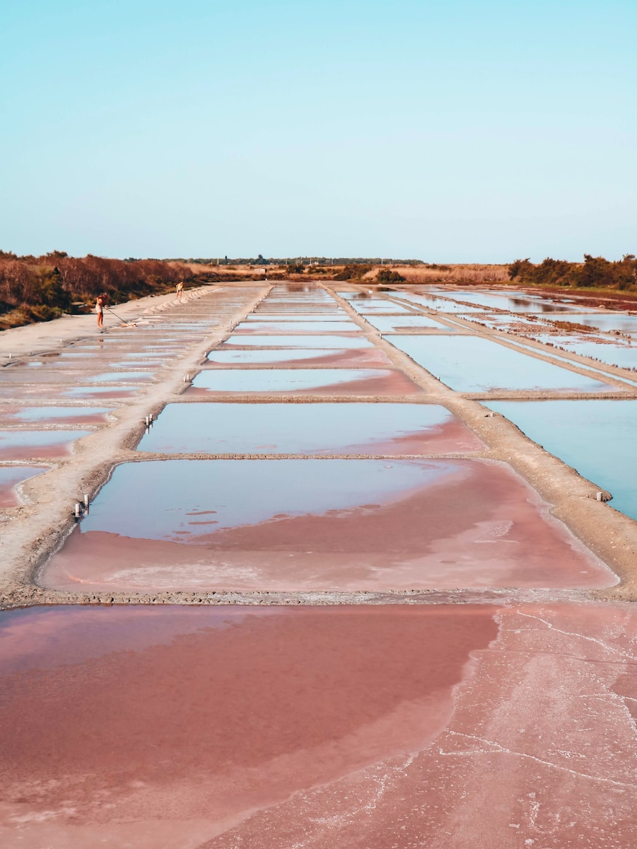 a man walking across a large salt field